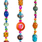 Detail of vibrant glass bead strands on colorful bohemian wall hanging