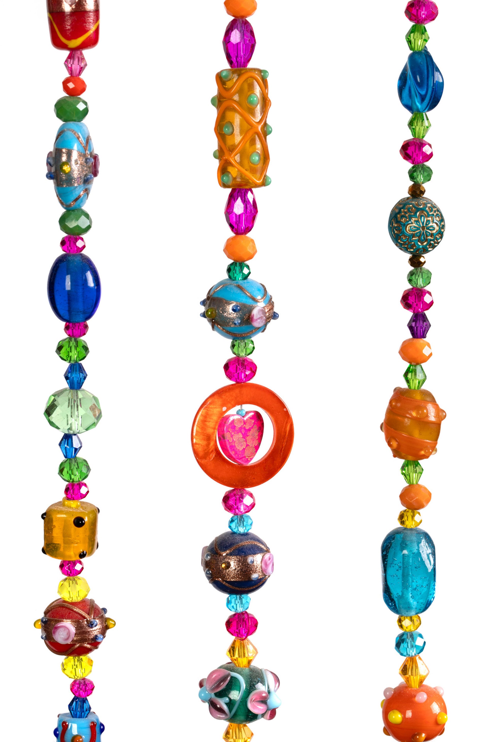 Detail of vibrant glass bead strands on colorful bohemian wall hanging