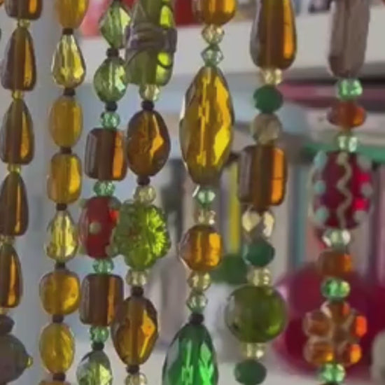 handmade glass bead strands with brown amber and green colors