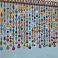 close up colorful lampwork glass beads on handmade beaded curtain
