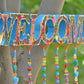 Bohemian Colorful Handmade Welcome Sign With Brass Bells and fabric tassels